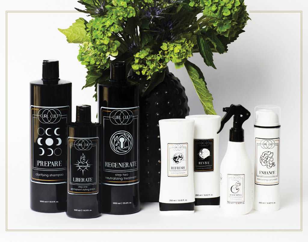 Hair care products arranged with a plant in the background.