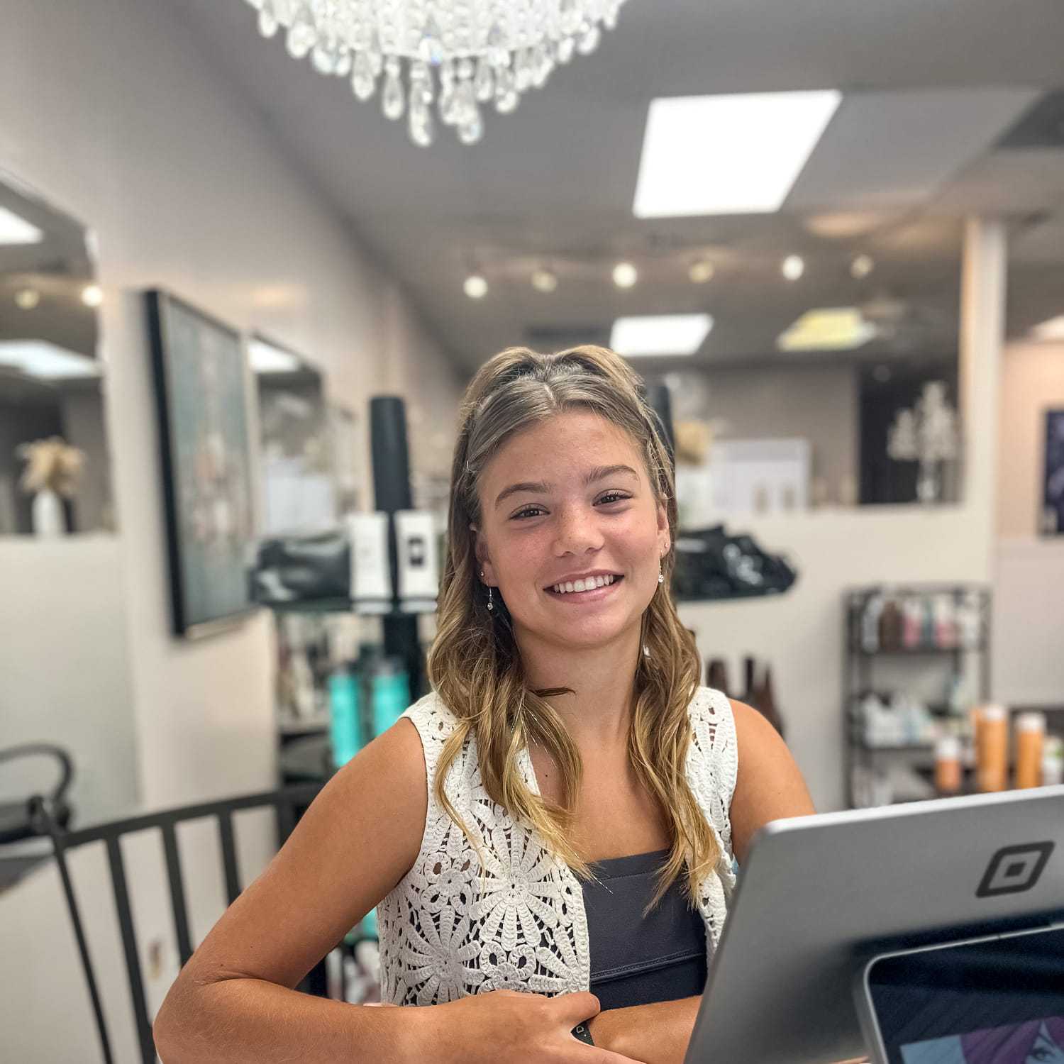 Portrait of Mady Johnson, a professional stylist at Glitter Hair Salon, showcasing their expertise and style.