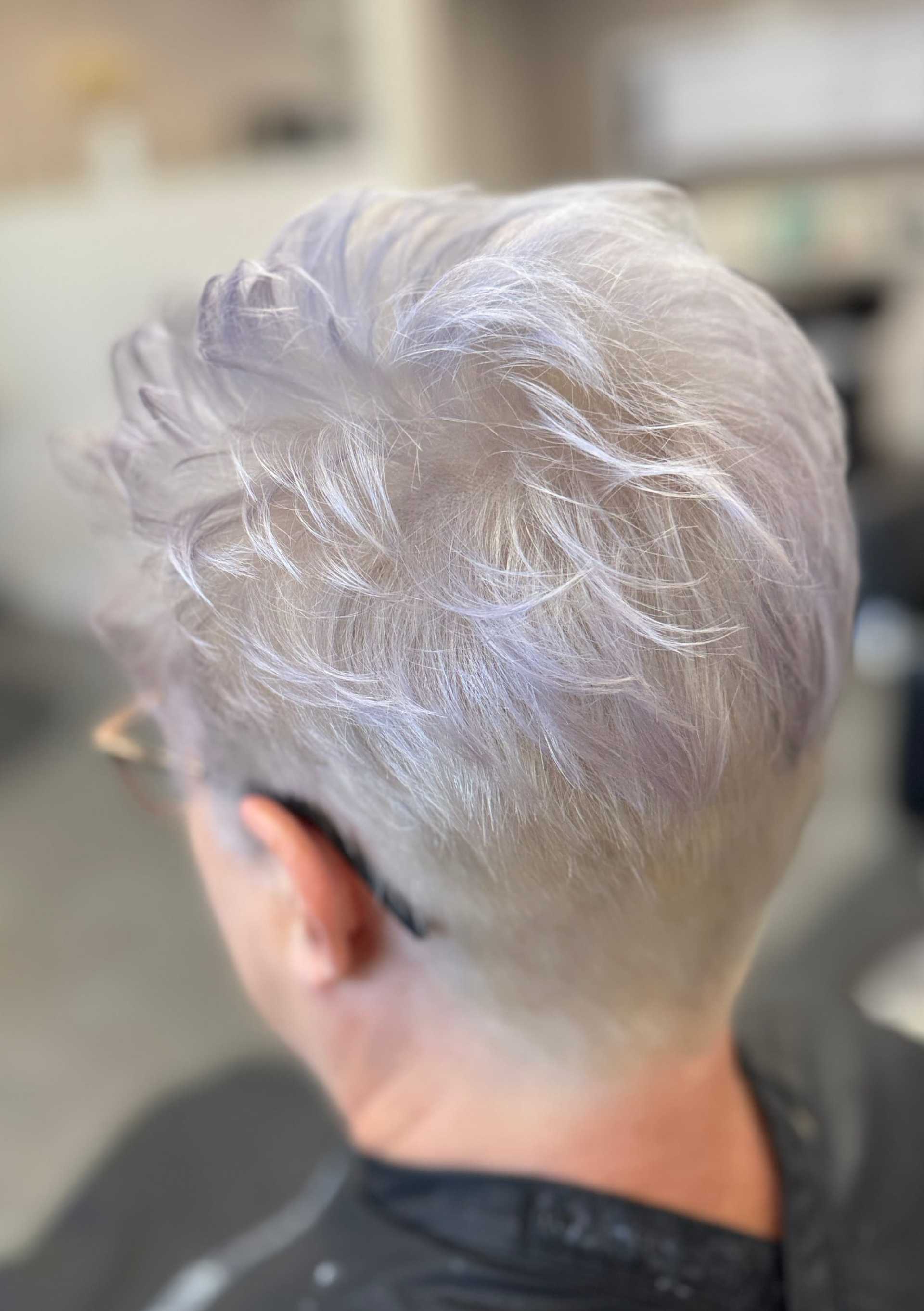 Short silver pixie haircut with soft, layered texture viewed from the back.