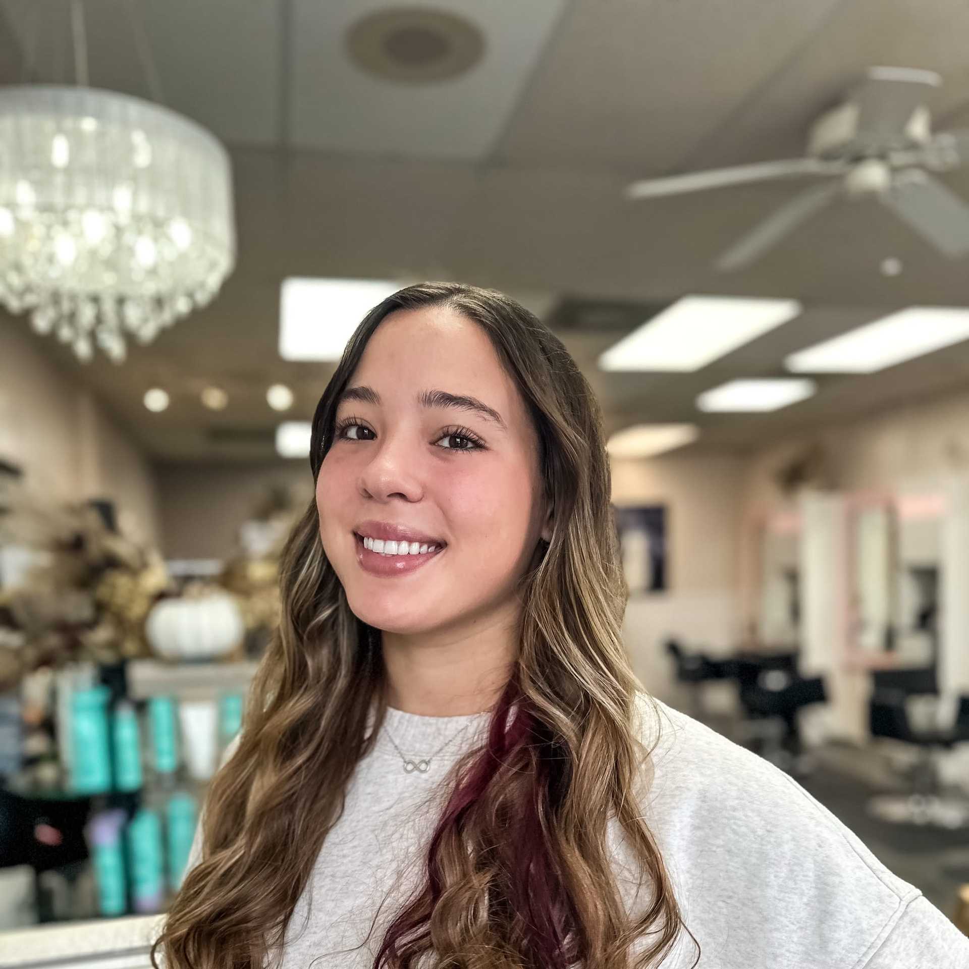 Portrait of Ava Johnson, a professional stylist at Glitter Hair Salon, showcasing their expertise and style.