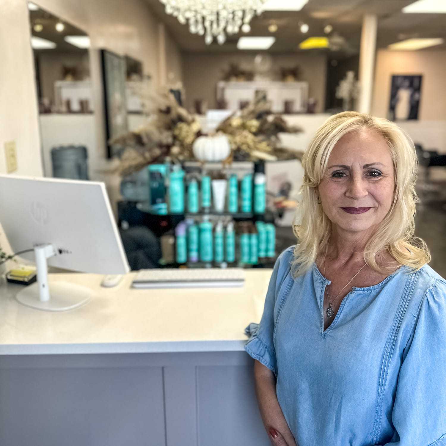Portrait of Donna Ducharme, a professional stylist at Glitter Hair Salon, showcasing their expertise and style.