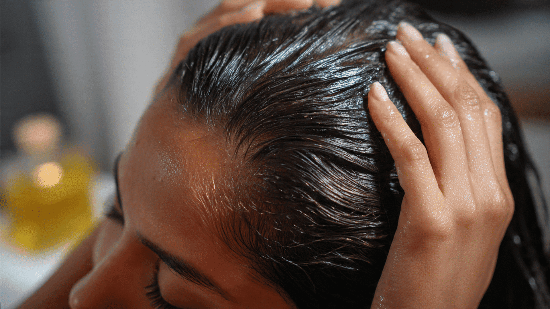 Washing hair with shampoo, hands massaging scalp. Healthy hair care routine.