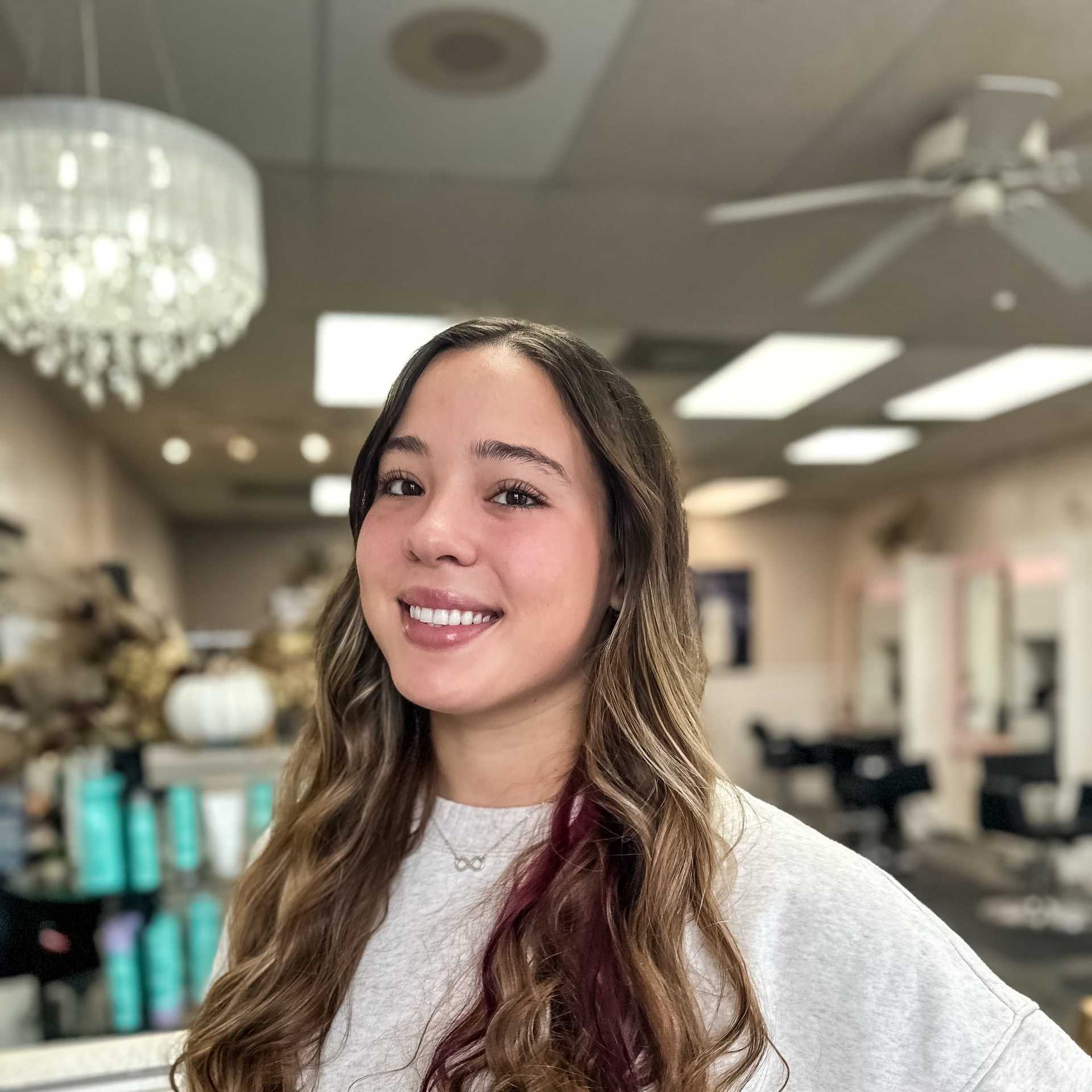 Portrait of Ava Johnson, a professional stylist at Glitter Hair Salon, showcasing their expertise and style.